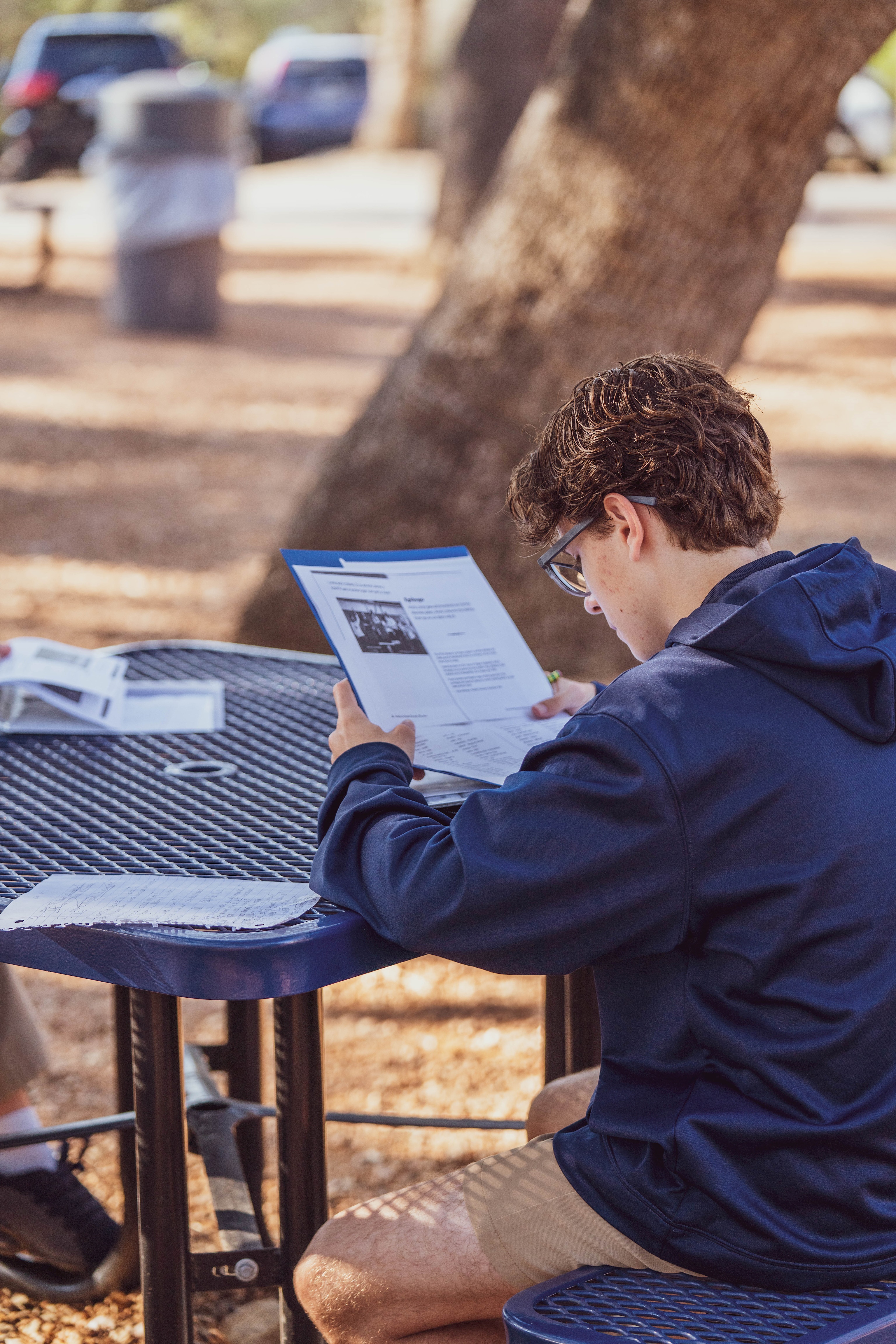 Secondary student doing classwork outside