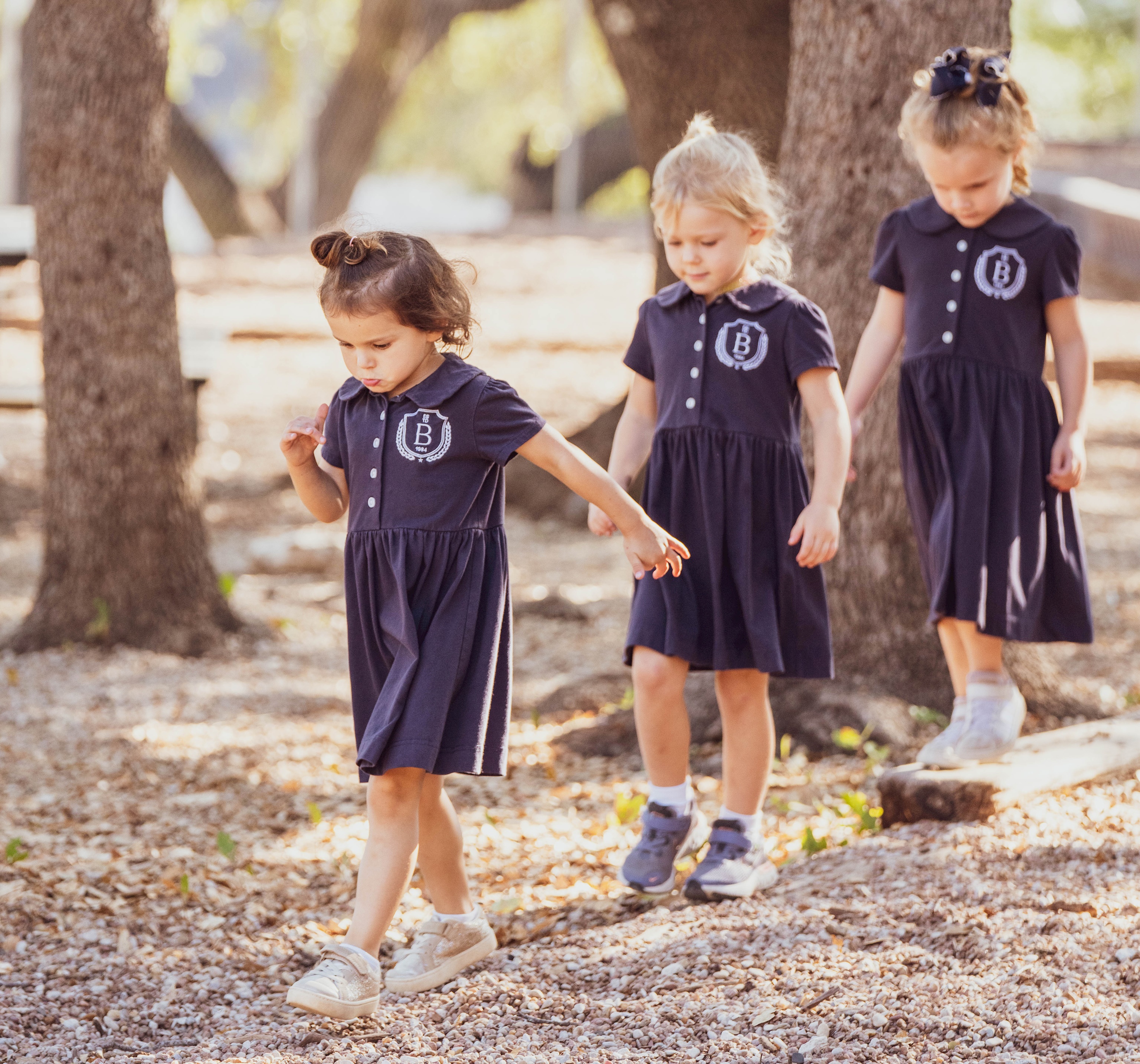 3 elementary students following each other